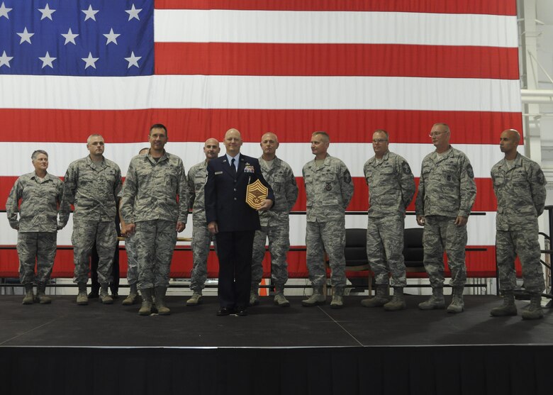 Many of the chiefs of the 442nd Fighter Wing join Command Chief Master Sgt. James Nudd, Command Chief of the 442nd FW, and Chief Master Sgt. Brian Card, 442nd Aircraft Maintenance Squadron weapons flight chief, on stage during Card's promotion ceremony at Whiteman Air Force Base, Mo., Oct. 15, 2016. Card was previously active-duty until he joined the 442nd AMXS in 2006. (U.S. Air Force photo/Senior Airman Missy Sterling)