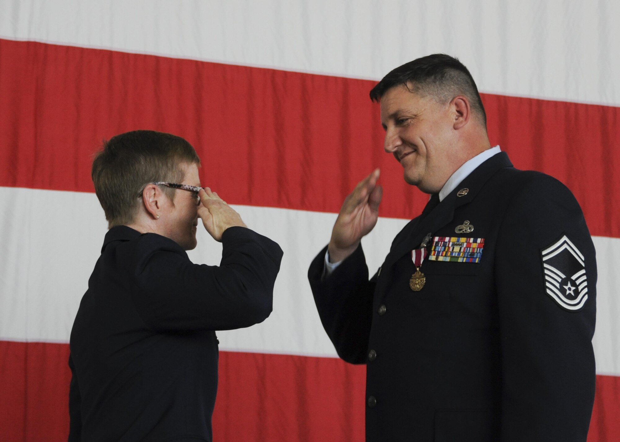 Senior Master Sgt. Anthony Axton, 442nd Aircraft Maintenance accessory flight chief, salutes Col. Anne Yelderman, 10th Air Force Emergency Preparedness Liaison Officer, after he was presented the Meritorious Service Medal during his retirement ceremony at Whiteman Air Force Base, Mo., Oct. 16, 2016. Axton was born at Whiteman while his father was stationed here. (U.S. Air Force photo/Senior Airman Missy Sterling)