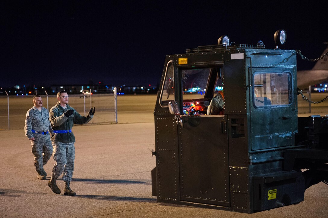 Air Force Senior Airman Matthew Welge, left, directs a cargo loader during exercise Red Flag-Alaska 17-1 at Joint Base Elmendorf-Richardson, Alaska, Oct. 11, 2016. Welge is an aeria lport specialist assigned to the 621st Contingency Response Support Squadron. Red Flag-Alaska is a series of Pacific Air Forces commander-directed field training exercises for U.S. and partner nation forces, providing combined offensive counter air, interdiction, close-air support, and large force employment training in a simulated combat environment. Air Force photo by Master Sgt. Joseph Swafford