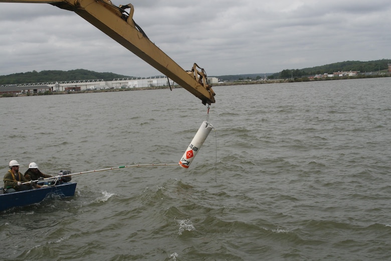 PCCI, Inc., a marine and environmental engineering company, installs a buoy in the Potomac River Oct. 5. The buoy is one of 31 marking the restricted waters adjacent to Marine Corps Air Facility Quantico.
