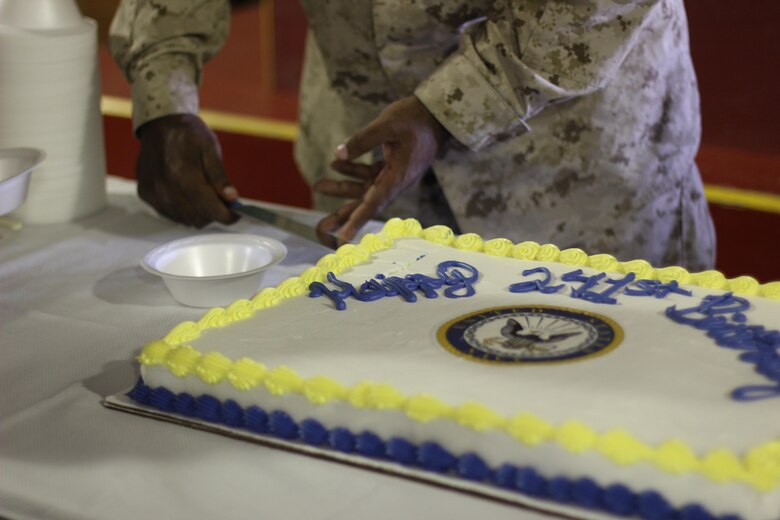 Lieutenant commander Arthur L. Wiggins Jr. cuts the first piece of the cake for the oldest sailor to pass to the youngest sailor at Camp Wilson, Calif., Oct.13, 2016.  The cake was birthday gifts from the Marines to the sailor as a token of appreciation for the hard work the sailors have done in order for the Marines to complete their mission. (U.S. Marine Corps photo by Lance Cpl. Juan A. Soto-Delgado)