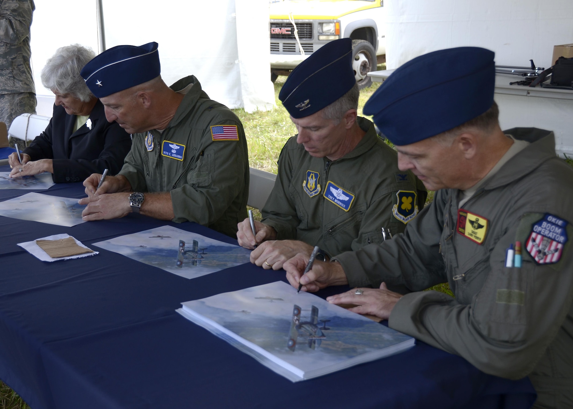 (left to right) Susan d’Olive, daughter of 1st Lt. Charles d’Olive, the last officially recognized U.S. “Ace” of World War I, Brig. Gen. Vito Addabbo, Mobilization Assistant to the Commander, Air Force Global Strike Command, Barksdale Air Force Base, Louisiana, Lt. Col. James Morriss, vice commander of the 307th Bomb Wing, Barksdale AFB, and Senior Master Sgt. Darby Perrin, an Air Force artist from the 465th Air Refueling Squadron, Tinker Air Force Base, Oklahoma, sign lithographs of Perrin’s artwork at the National Museum of the United States Air Force in Ohio, Oct. 1, 2016. Perrin unveiled a picture at the event depicting Susan’s father, 1st Lt. Charles d’Olive’s victory over three German fighter planes during World War I. 