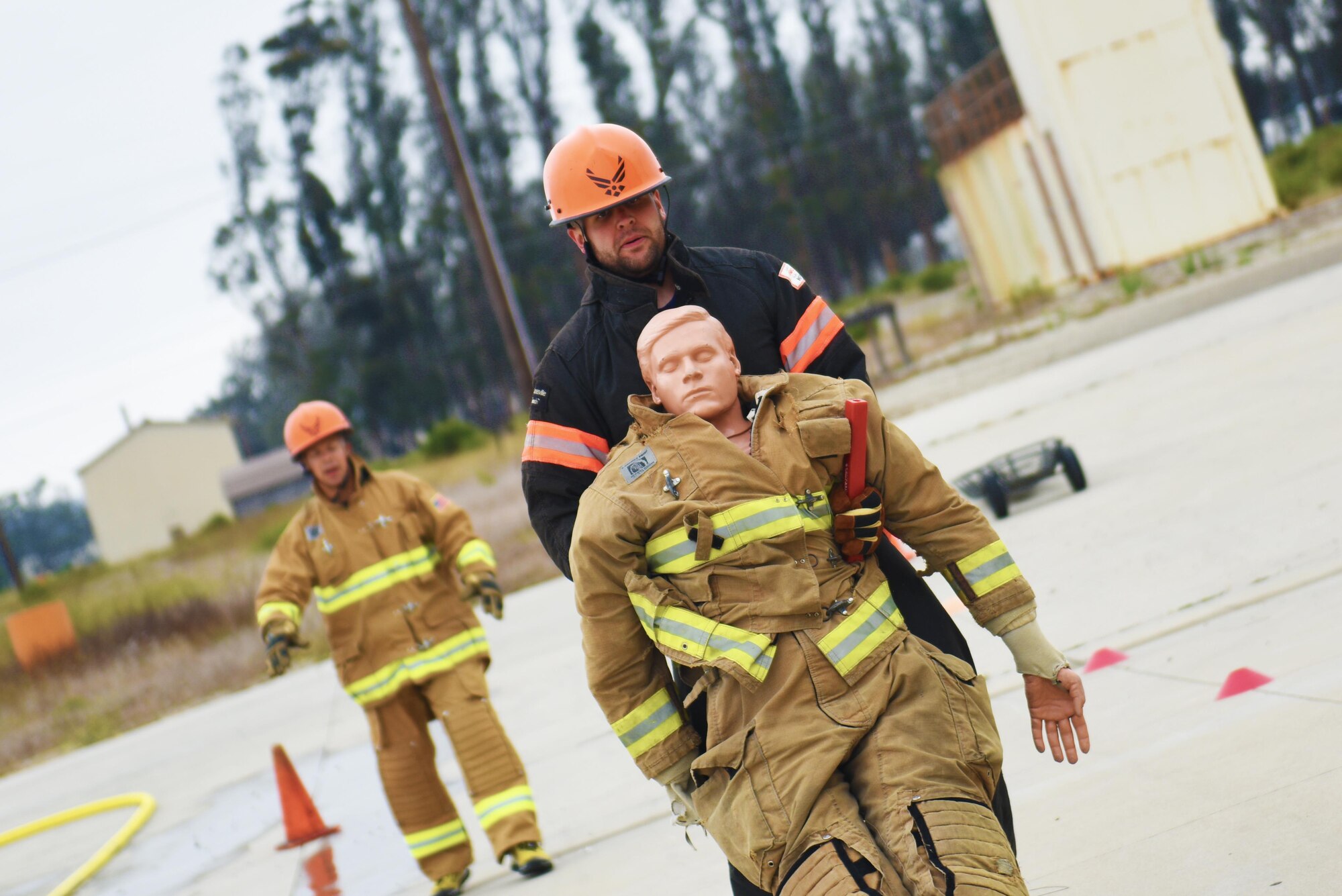Senior Airman Adam Schaefer, 30th Civil Engineer Squadron fire engineer, completes a dummy drag as he trains for the Scott Firefighter Combat Challenge while Senior Master Sgt. Bronson Peters, 30th CES deputy fire chief, coaches him in the background, Aug. 20, 2016, Vandenberg Air Force Base, Calif.  This year the team from Vandenberg had many first time competitors, including Schaefer who was awarded the ‘Greenhorn’ award for the fastest first time run. (U.S. Air Force photo by Senior Airman Ian Dudley/Released)