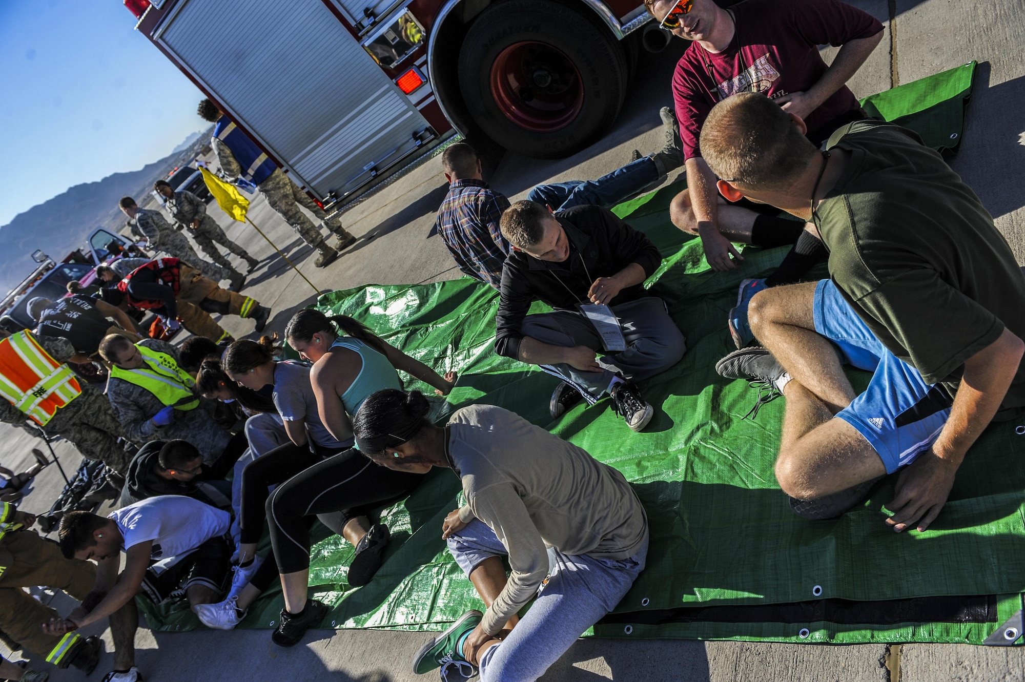 Simulated casualties are triaged after being moved from the scene of an aircraft crash during the Major Accident Recovery Exercise at Nellis Air Force Base, Nev., Oct. 13, 2016. The MARE will be used as a learning tool to provide feedback on what went right and what areas could be improved on. (U.S. Air Force photo by Airman 1st Class Kevin Tanenbaum/Released)