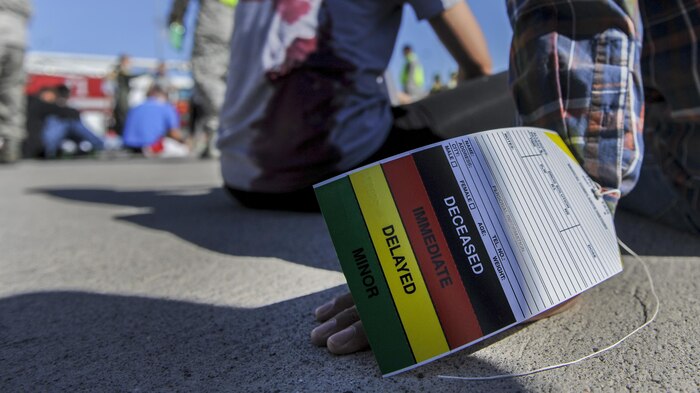 A patient wears a triage label on his hand after a simulated aircraft crash during a Major Accident Recovery Exercise at Nellis Air Force Base, Nev., Oct. 13, 2016. The exercise will be used for educational purposes and will provide feedback on the areas the participating squadrons excelled in and what areas that could be improved on. (U.S. Air Force photo by Airman 1st Class Kevin Tanenbaum/Released)