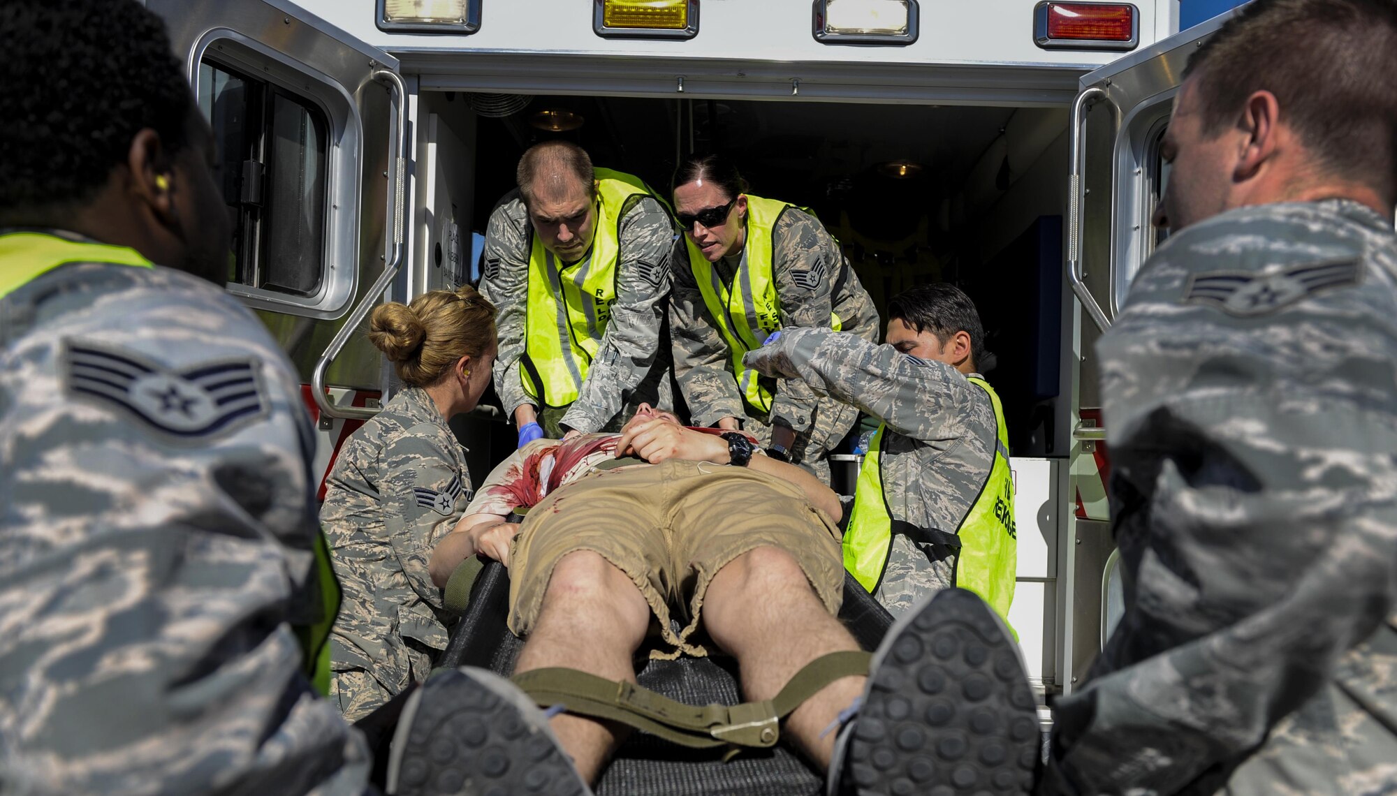 The 99th Medical Group emergency responders load a simulated casualty into an ambulance during the Major Accident Recovery Exercise at Nellis Air Force Base, Nev., Oct. 13, 2016. The MARE objective is that the Airmen participating will learn new ways to overcome shortfalls and enhance their unit for the better. (U.S. Air Force photo by Airman 1st Class Kevin Tanenbaum/Released)