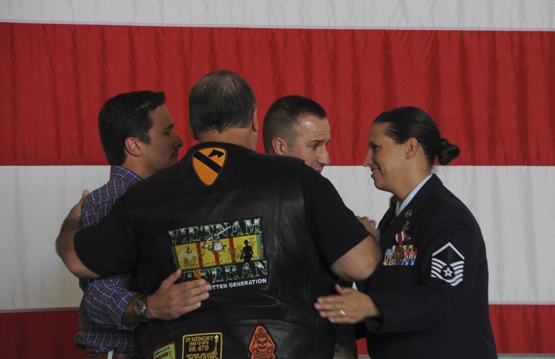 U.S. Air Force Master Sgt. Denise Jump, 442nd Fighter Wing newcomers flight lead, hugs her family members during her retirement ceremony at Whiteman Air Force Base, Mo., Sept. 9, 2016. Jump's father and older brother served in the U.S. Army and U.S. Navy respectively and her younger brother serves in the U.S. Army Reserve. (U.S. Air Force photo/Senior Airman Missy Sterling)