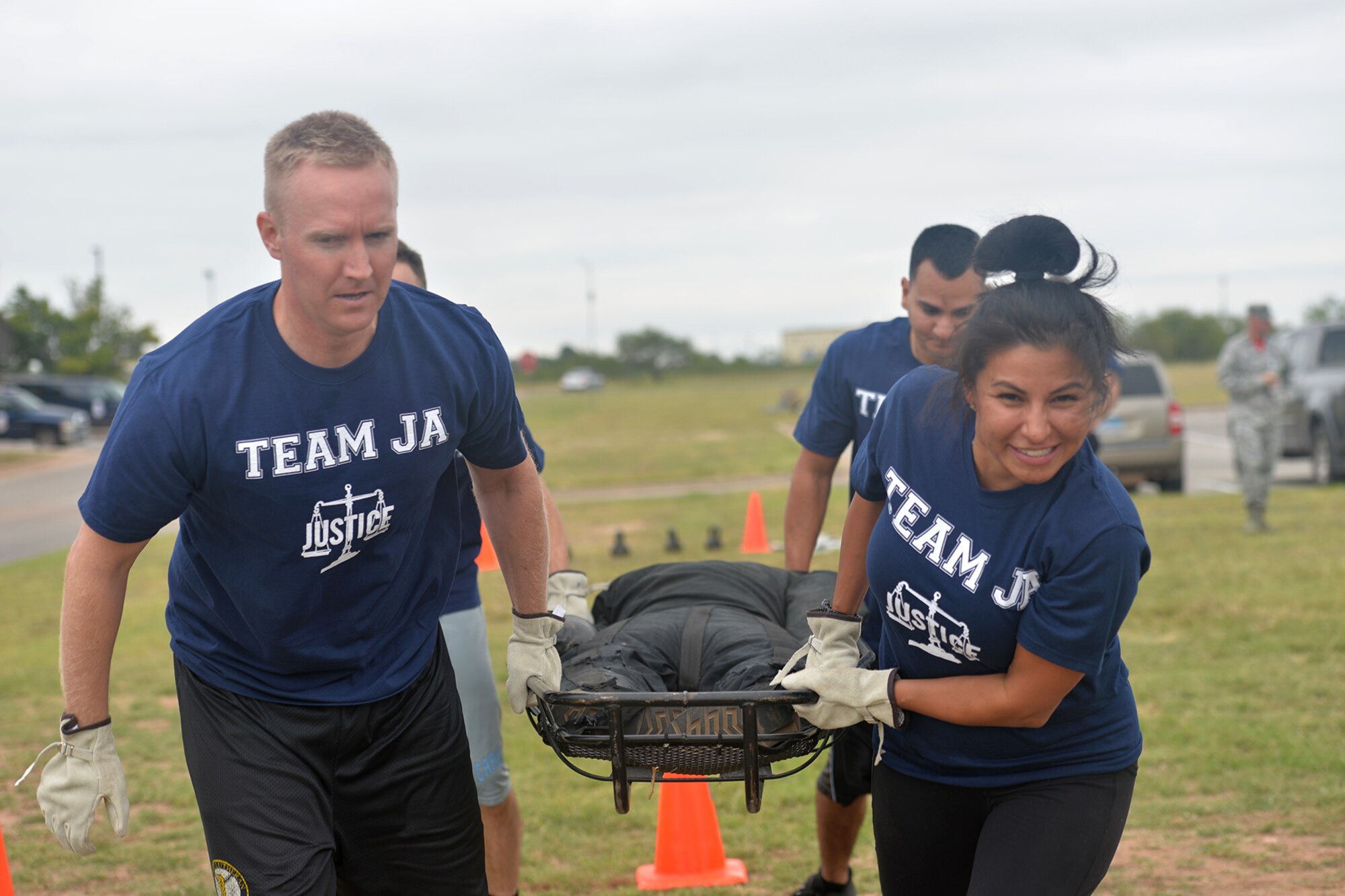 Team JA carries a dummy in a litter during the Annual Fire Muster Challenge at Goodfellow Air Force Base, Texas, Oct. 14, 2016.  Participants carried the 200 pound litter over 20 feet. (U.S. Air Force photo by Airman 1st Class Randall Moose/Released)