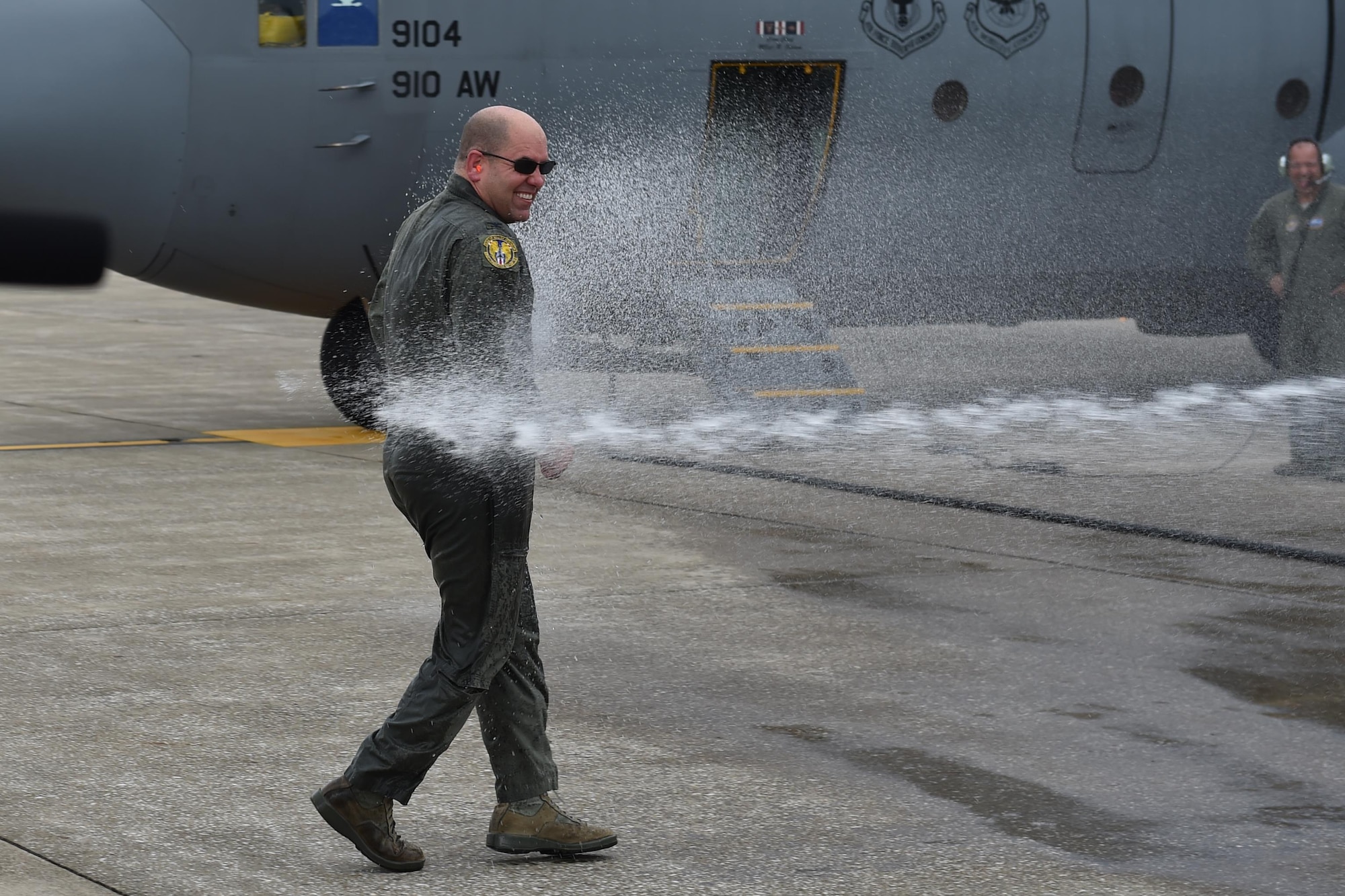 Col. James Dignan, 910th Airlift Wing commander, gets hosed down by family members after his final flight with the unit here, Oct. 2, 2016. Dignan moved to a new assignment at the Pentagon Oct. 18, after commanding YARS for nearly four years. (U.S. Air Force photo/Tech. Sgt. Jim Brock)