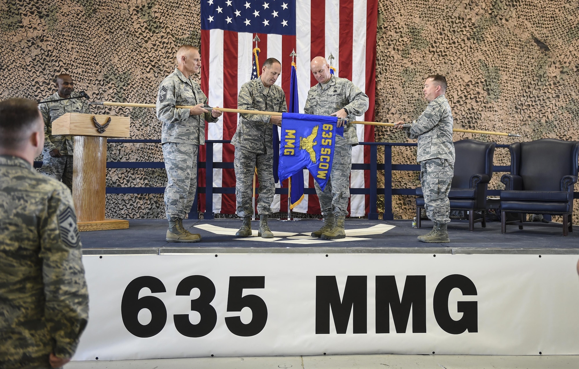 Lt. Gen Lee Levy, commander Air Combat Command and Col. Joseph Moehlmann, commander 635th Materiel Maintenance Group unfurled the new banner during the 49th Materiel Maintenance Group transition to the 635th MMG re-designation ceremony Oct. 20, 2016 at Holloman Air Force Base N.M. The Ceremony marks the historic event of the Materiel Maintenance Group moving from Air Combat command over to Air Force Material Command. (U.S. Air Force photo by Staff Sgt. Stacy Jonsgaard)