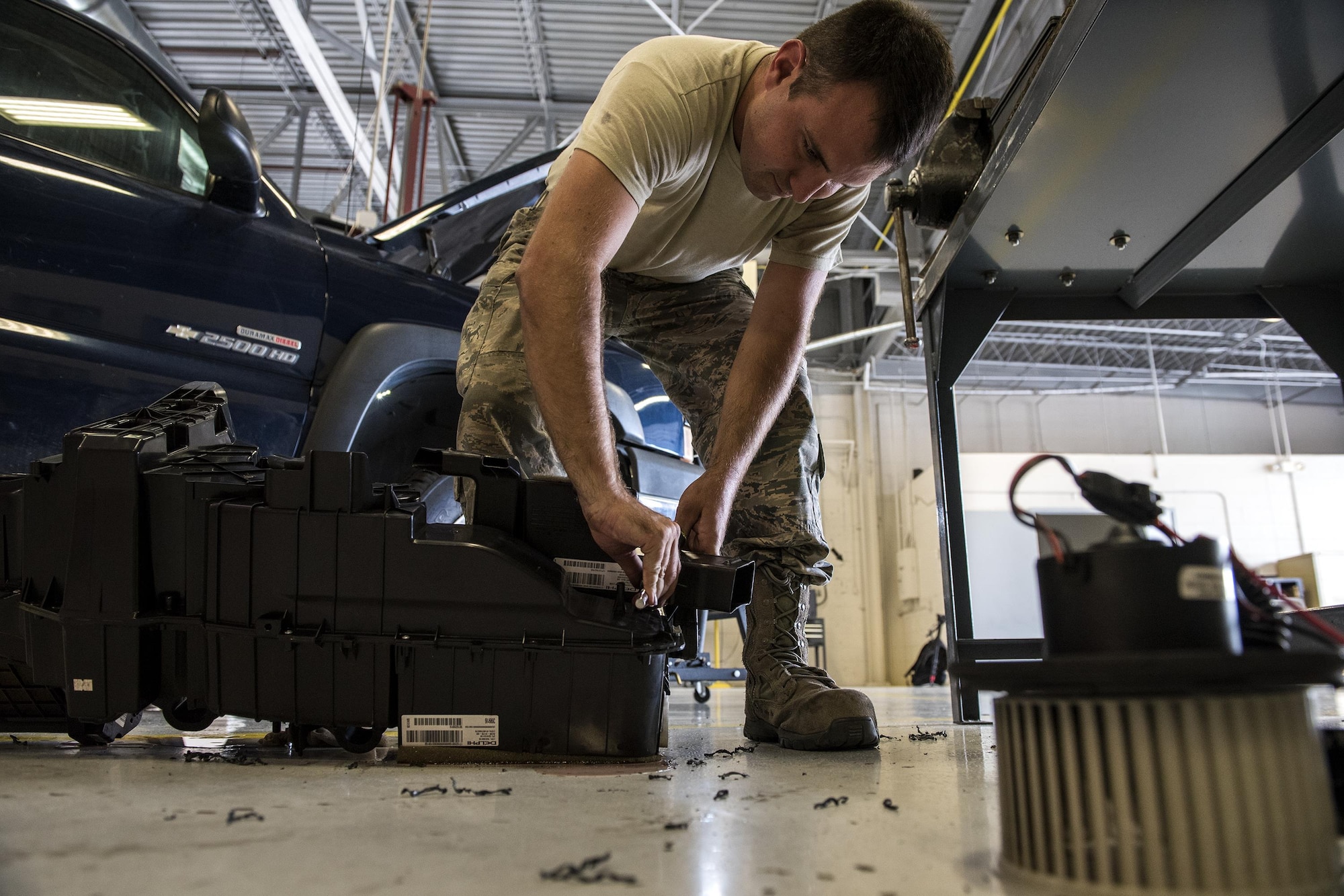 Staff Sgt. Adam Hix, 23d Logistics Readiness Squadron vehicle maintenance technician, replaces screws on an air conditioning and heating housing unit, Oct. 12, 2016, at Moody Air Force Base, Ga. Technicians replaced the air conditioning housing unit in the truck because the previous one shattered. (U.S. Air Force photo by Airman 1st Class Janiqua P. Robinson) 