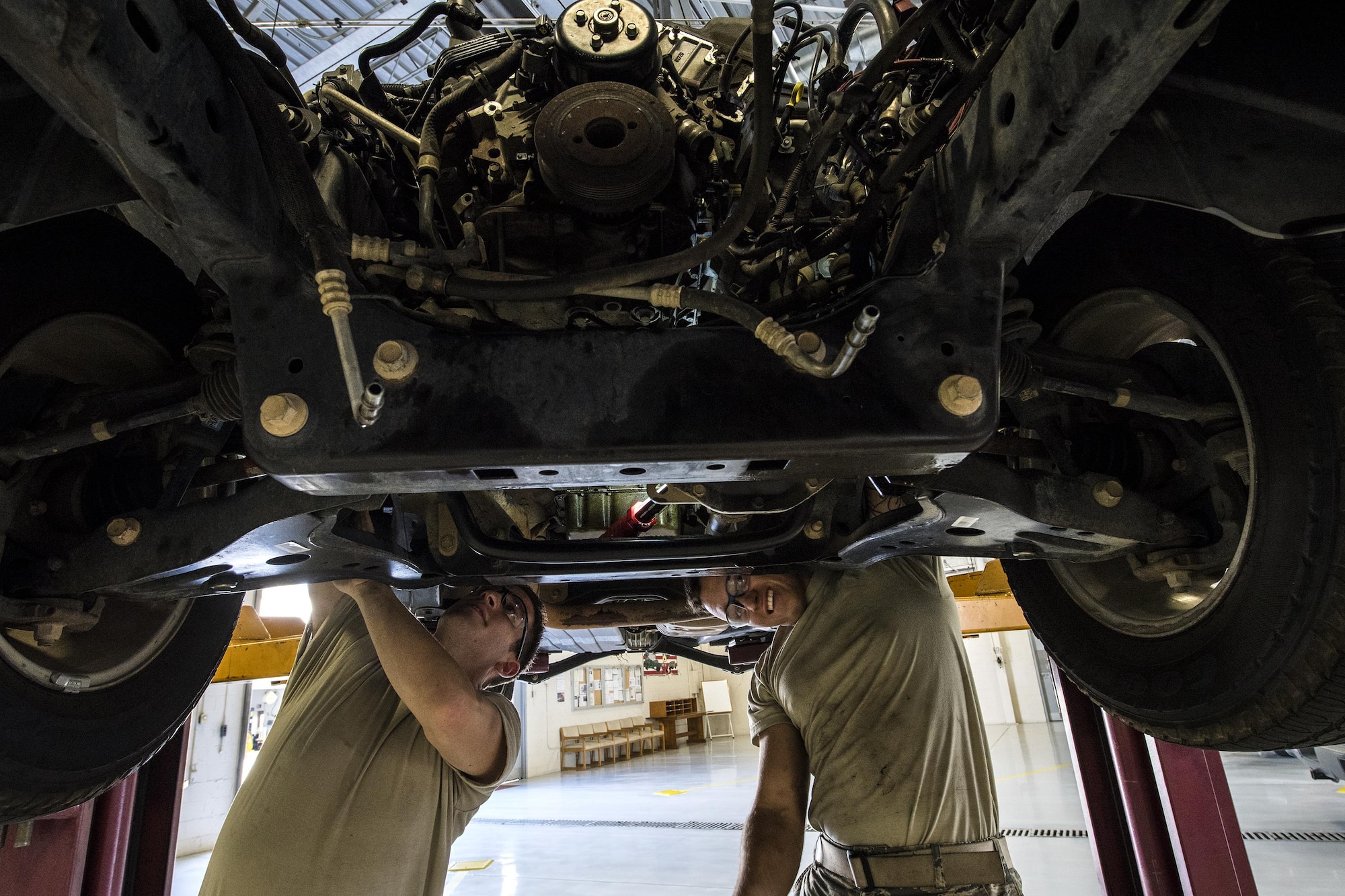 Senior Airman Corbin Mellor, left, and Airman 1st Class Gavin McClaskey, 23d Logistics Readiness Squadron vehicle maintenance technicians, search for bolts connected to an engine, Oct. 12, 2016, at Moody Air Force Base, Ga. After loosening the bolts, the technicians removed the V6 engine to replace and repair the assembly that connects the crank shaft to the camshaft. (U.S. Air Force photo by Airman 1st Class Janiqua P. Robinson)