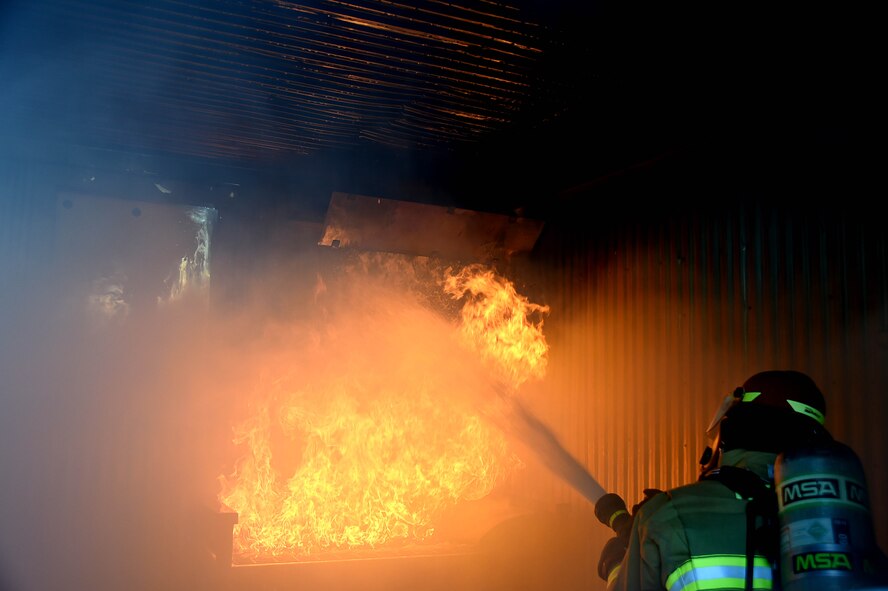 Firefighters assigned to the 99th Civil Engineer Squadron Fire Protection Flight, extinguish a controlled fire during a training exercise Sept. 23, 2016, at Creech Air Force Base, Nev. During the burn, the firefighters were accompanied by three distinguished visitors. (U.S. Air Force photo by Airman 1st Class James Thompson) 
