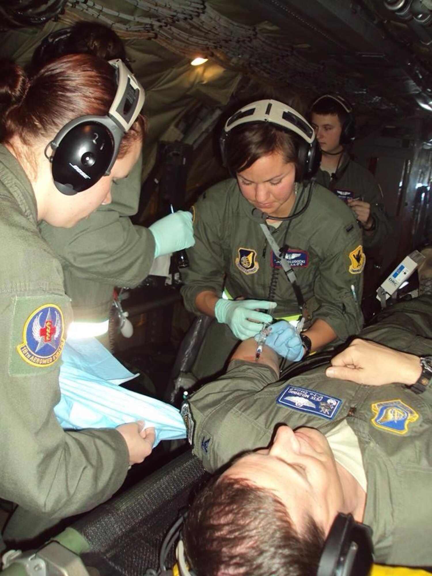 Capt. Slugocki inserts an IV into a simulated patient during a training mission at Kadena Air Base, Japan.

