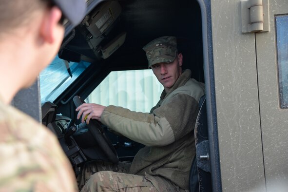 Senior Airman Nicholas Campbell, 741st Missile Security Forces Squadron convoy response force member, instructs Airmen on a slalom course during a maneuverability exercise Oct. 19, 2016, at Malmstrom Air Force Base, Mont. In the slalom, Airmen drove a Ballistic Armored Response Counter Attack Truck, otherwise known as a BEARCAT, through gravel at 15, 17, 20 and 22 miles per hour, avoiding evenly spaced cones while maintaining speed, simulating physical obstacles during an attack while escaping opposing forces. (U.S. Air Force photo/Airman 1st Class Daniel Brosam)