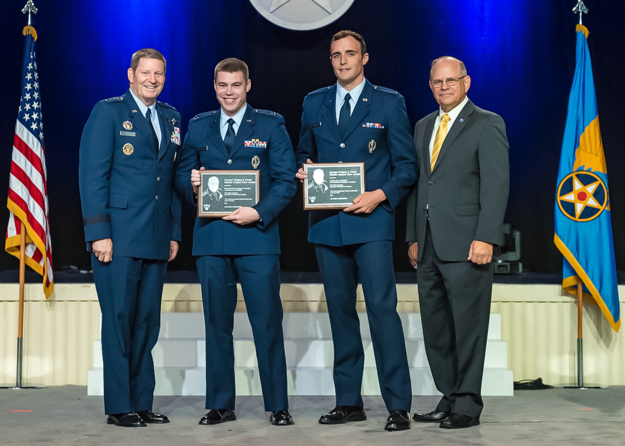 Gen. Robin Rand, Global Strike Command commander, left, and retired Brig. Gen. Scott Van Cleef, Air Force Association alumni, right, present the General Thomas S. Power Award to Capt. Ian Sylvester and 1st Lt. Michael McCrary, both of 341st Operations Group, at the Air, Space and Cyber Conference National Aerospace Awards, hosted by the Air Force Association on Washington D.C., Sept. 19.  This award is presented to the best missile team in the Air Force.  