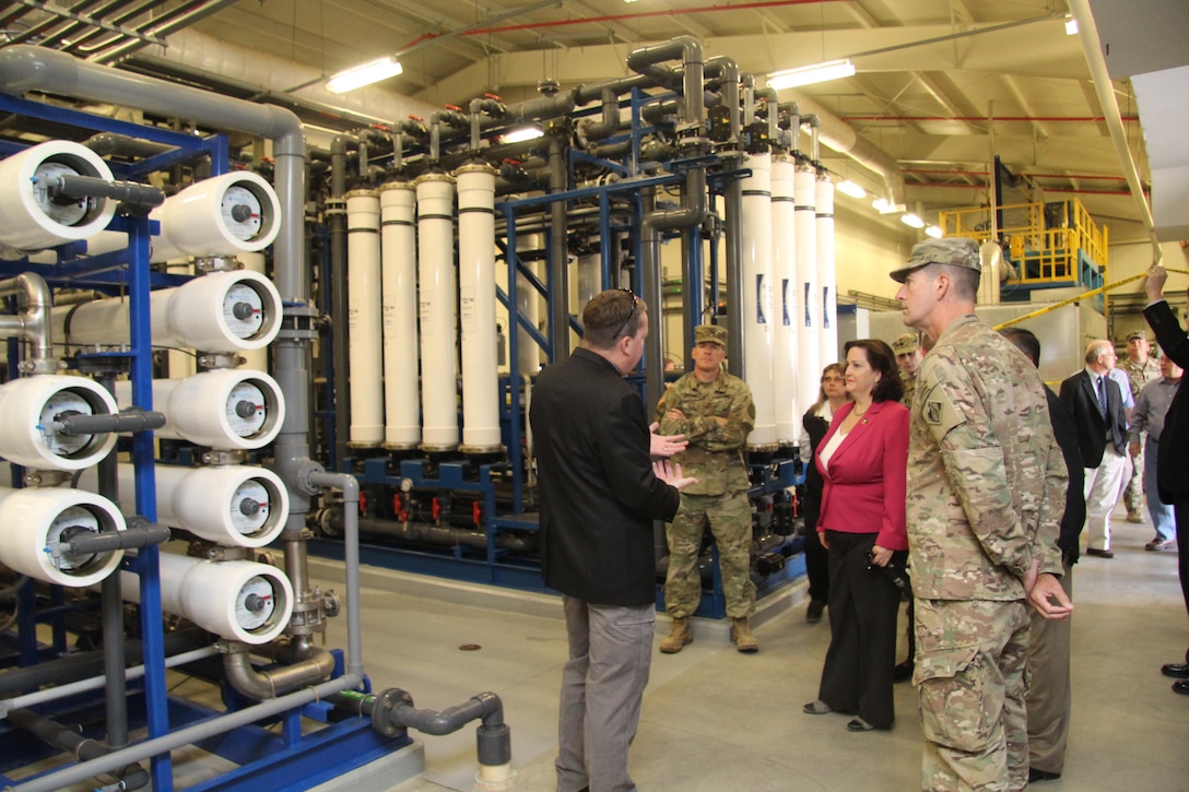 Christopher Woodruff, water resources manager, Fort Irwin Department of Public Works (left) briefs Assistant Secretary of the Army for Installations, Energy, and Enviorment Katherine Hammack (center) and South Pacific Division Commander Col. Pete Helmlinger (right) on the second phase of the water treatment process at the Irwin Water Works, at Fort Irwin, California Oct. 13.

