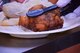 An apple fritter is served next to a brat with sauerkraut during the annual 50th Force Support Squadron’s Expo and Information Fair at Schriever Air Force Base, Colorado, Wednesday, Oct. 19, 2016. The German fare played into the event’s Oktoberfest theme. (U.S. Air Force photo/Brian Hagberg)