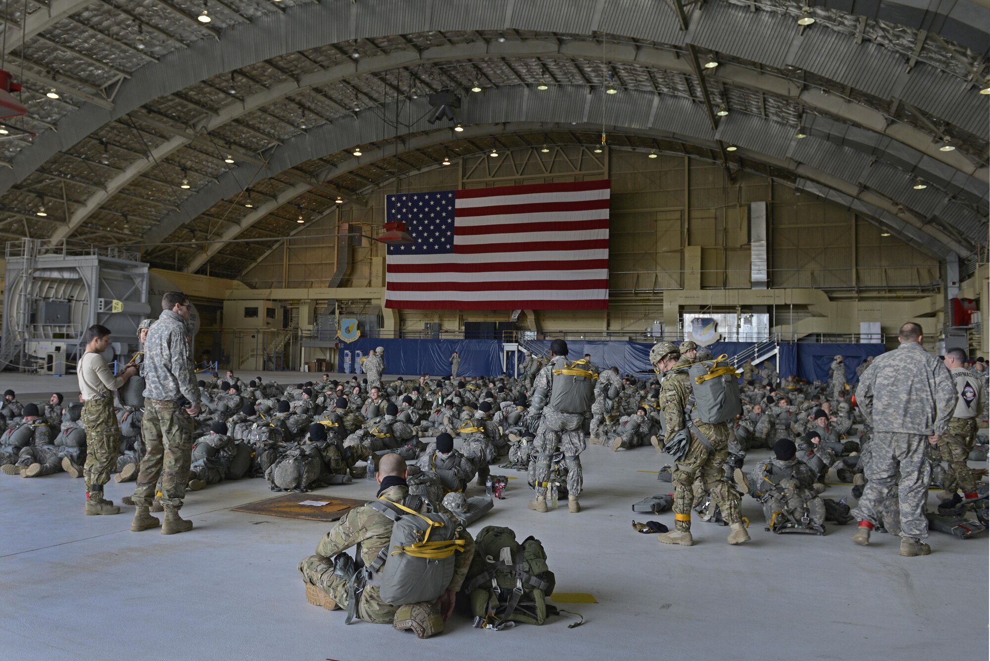 Paratroopers with the 4th Infantry Brigade Combat Team (Airborne), 25th Infantry Division, U.S. Army Alaska, and Tactical Air Control Party Airmen with the 3rd Air Support Operations Squadron, gather at Hangar 1 before a jump at Joint Base Elmendorf-Richardson, Alaska, Oct. 19, 2016. The jump was part of Red Flag-Alaska 17-1, a training exercise for U.S. and international forces flown under simulated air combat conditions. 