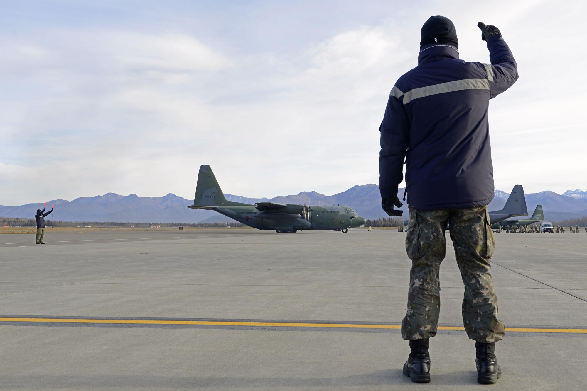 An airman with the Republic of Korea Air Force marshals a ROKAF C-130 Hercules during Red Flag Alaska 17-1 at Joint Base Elmendorf-Richardson, Alaska, Oct. 19, 2016. During Red Flag-Alaska 17-1, approximately 2,095 U.S. service members will participate in the exercise – approximately 1,295 personnel from outside Alaska and 203 international visitors. 