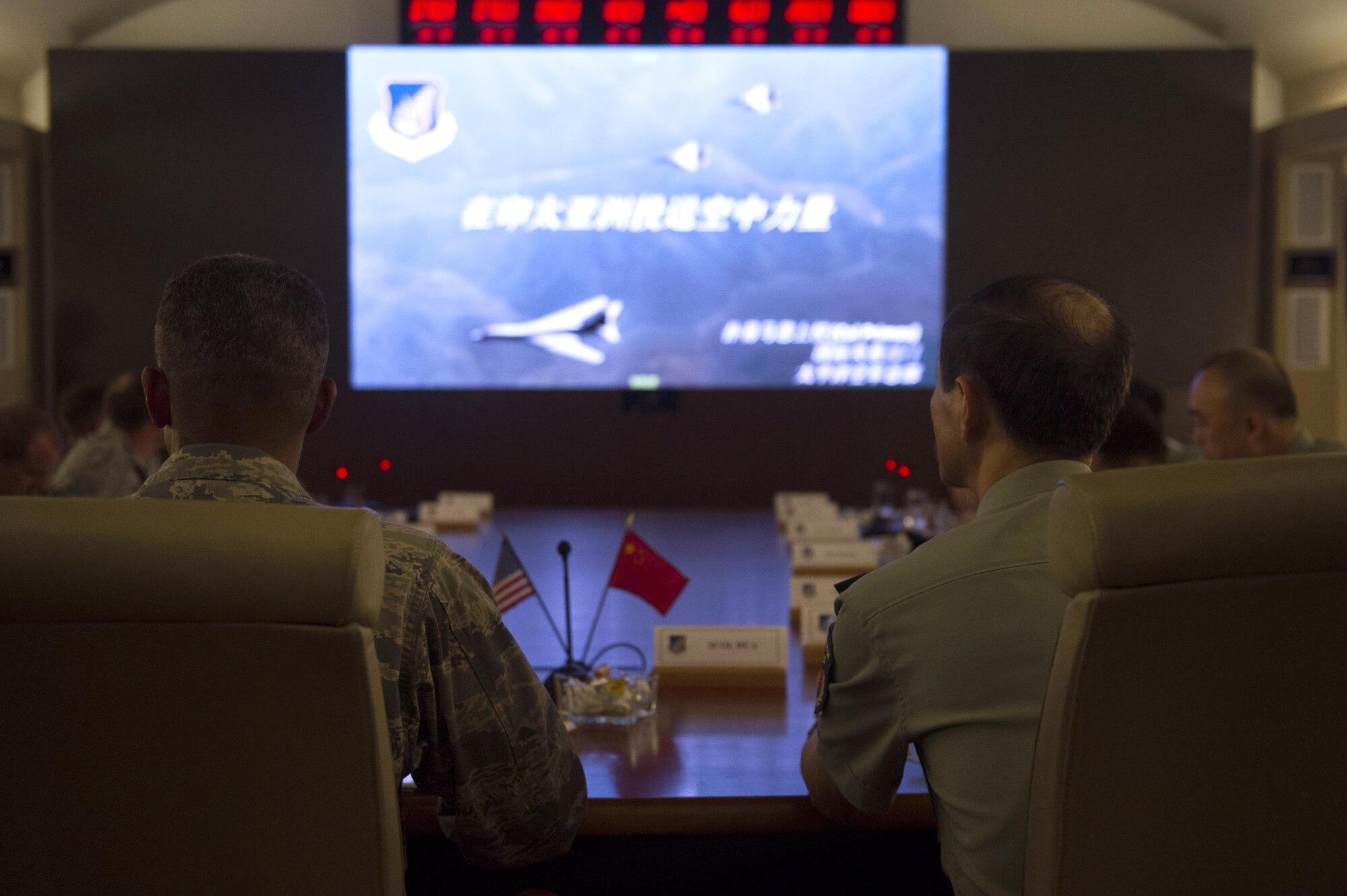 People's Liberation Army Senior Col. Hua Bo and U.S. Air Force Col. Art Primas, Pacific Air Forces International Affairs division chief, receive a briefing during a mid-level officer exchange at Joint Base Pearl Harbor-Hickam, Hawaii, Oct. 18, 2016. The PLA delegation visited PACAF as part of an annual exchange tour that included a stop at U.S. Pacific Command. (U.S. Air Force photo by Staff Sgt. Alexander Martinez)