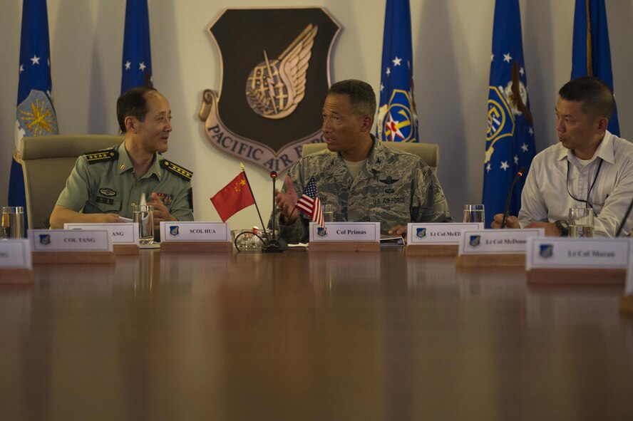 People's Liberation Army Senior Col. Hua Bo and U.S. Air Force Col. Art Primas, Pacific Air Forces International Affairs division chief, speak during a mid-level officer exchange at Joint Base Pearl Harbor-Hickam, Hawaii, Oct. 18, 2016. The PLA delegation visited PACAF as part of an annual exchange tour that included a stop at U.S. Pacific Command. (U.S. Air Force photo by Staff Sgt. Alexander Martinez)