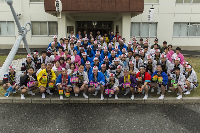 U.S. Marines and Sailors pose for a photo with members of Japan Maritime Self-Defense Force Fleet Air Wing 31 at Marine Corps Air Station Iwakuni before departing to the 60th Annual Iwakuni Festival in Iwakuni City, Japan, Oct. 16, 2016. The festival, hosted by the Iwakuni Festival Committee, consisted of 83 different organizations and approximately 800 people, making it one of the three largest festivals in Iwakuni. (U.S. Marine Corps photo by Lance Cpl. Aaron Henson)