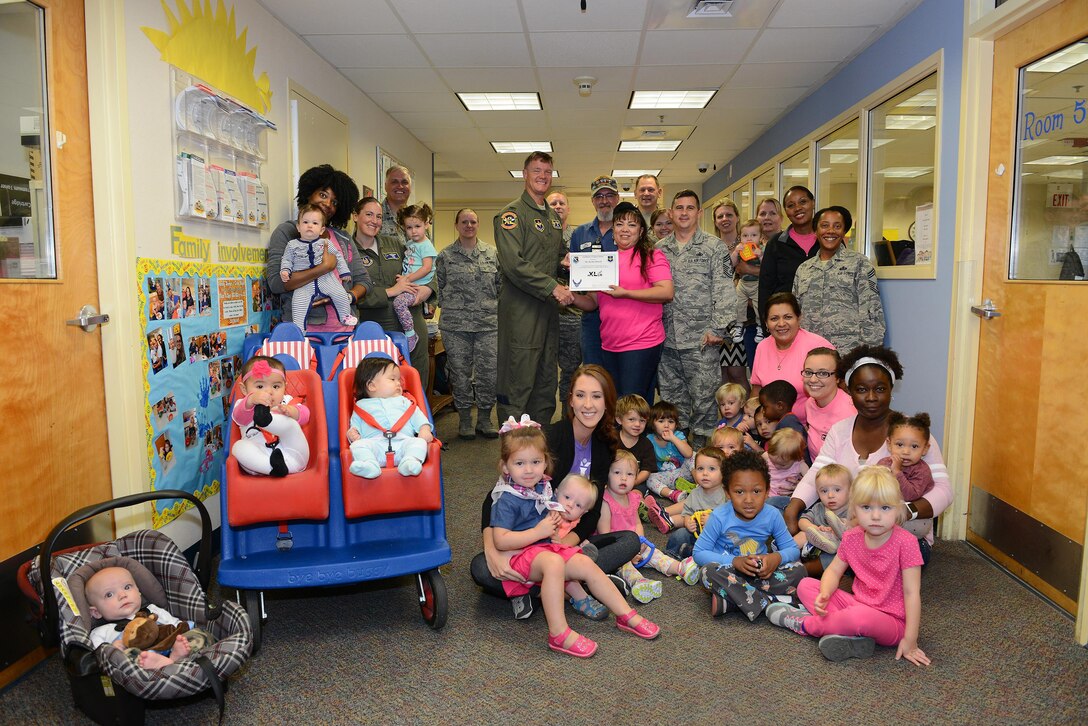 Bertha Murrell, 47th Force Support Squadron child and youth program technician (center), accepts the “XLer of the Week” award from Col. Thomas Shank (front left), 47th Flying Training Wing commander, on Laughlin Air Force Base, Texas, Oct. 12, 2016. The XLer is a weekly award chosen by wing leadership and is presented to those who consistently make outstanding contributions to their unit and Laughlin. (U.S. Air Force photo/Airman 1st Class Benjamin N. Valmoja)