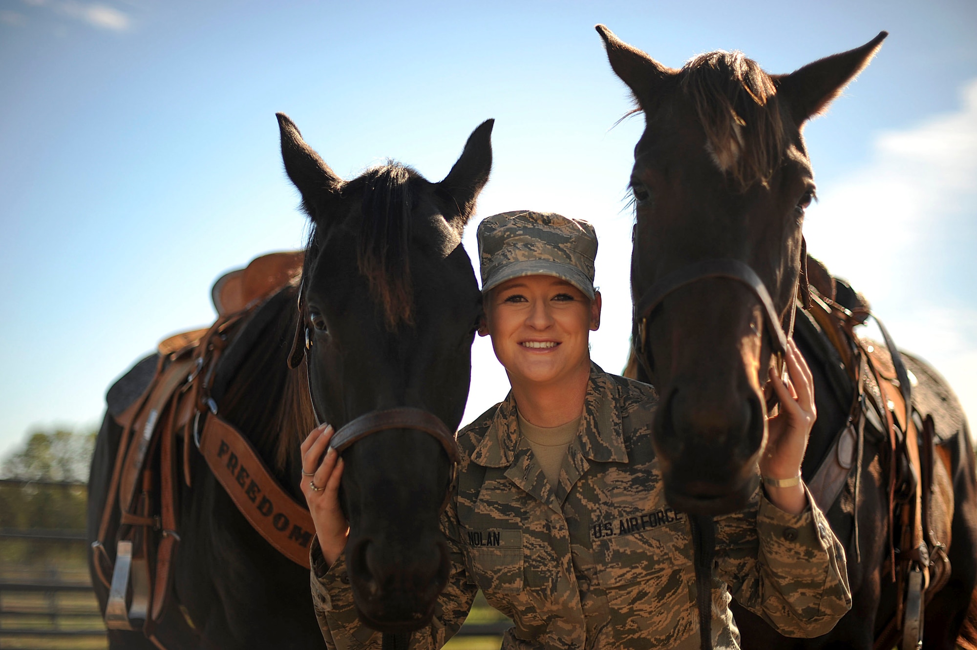 Airman 1st Class Lauren Nolan, 22nd Logistics Readiness Squadron materials management journeyman, poses for a photo with her horses, Tiz and Shoobie, Oct. 13, 2016, in Wichita, Kan. When Nolan moved to McConnell Air Force Base, Kan. her first duty station she had her horses shipped to the area and now boards them off-base in the local community. (U.S. Air Force photo/ Airman 1st Class Jenna K. Caldwell)