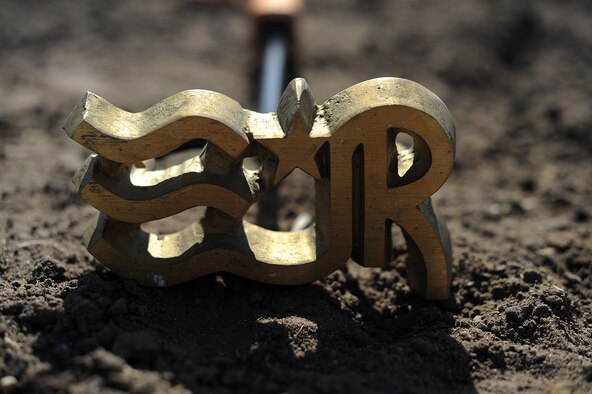 A horse brand sits in the dirt Oct. 13, 2016, in Wichita, Kan. The brand belongs to Airman 1st Class Lauren Nolan, a 22nd Logistics Readiness Squadron materials management journeyman. The L stands for her first name, the R stands for her middle name, Rae, and the stars and stripes represents her time in service. (U.S. Air Force photo/Airman 1st Class Jenna K. Caldwell)