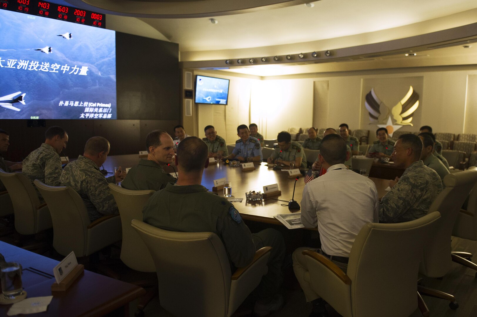 People's Liberation Army Senior Col. Hua Bo and U.S. Air Force Col. Art Primas, Pacific Air Forces International Affairs division chief, speak during a mid-level officer exchange at Joint Base Pearl Harbor-Hickam, Hawaii, Oct. 18, 2016. The PLA delegation visited PACAF as part of an annual exchange tour that included a stop at U.S. Pacific Command. (U.S. Air Force photo by Staff Sgt. Alexander Martinez)