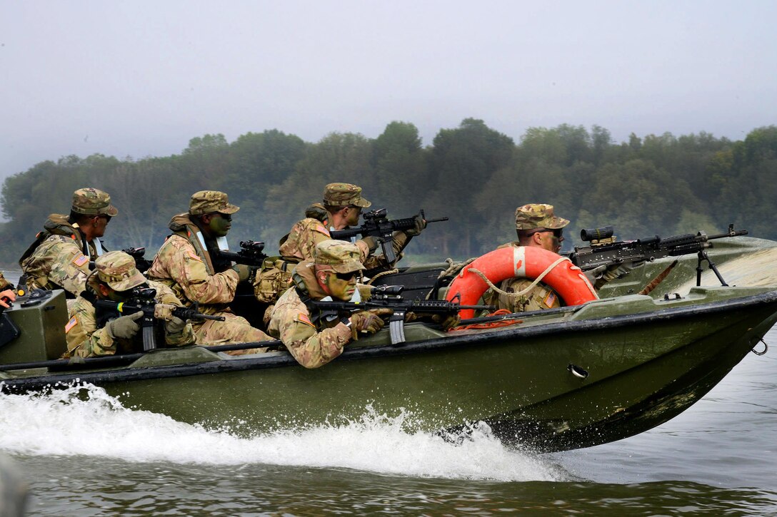 Soldiers provide security from a high-speed patrol boat while advancing toward their next objective during Livorno Shock, an exercise in Piacenza, Italy, Oct. 17, 2016. Army photo by Massimo Bovo