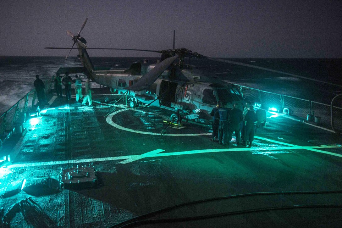 Sailors inspect an MH-60R helicopter on the flight deck of the USS Stout in the Red Sea, Oct. 16, 2016. The Stout is supporting maritime security operations and theater security cooperation efforts in the U.S. 5th Fleet area of operations. The helicopter is assigned to Helicopter Maritime Strike Squadron 37. Navy photo by Petty Officer 3rd Class Bill Dodge