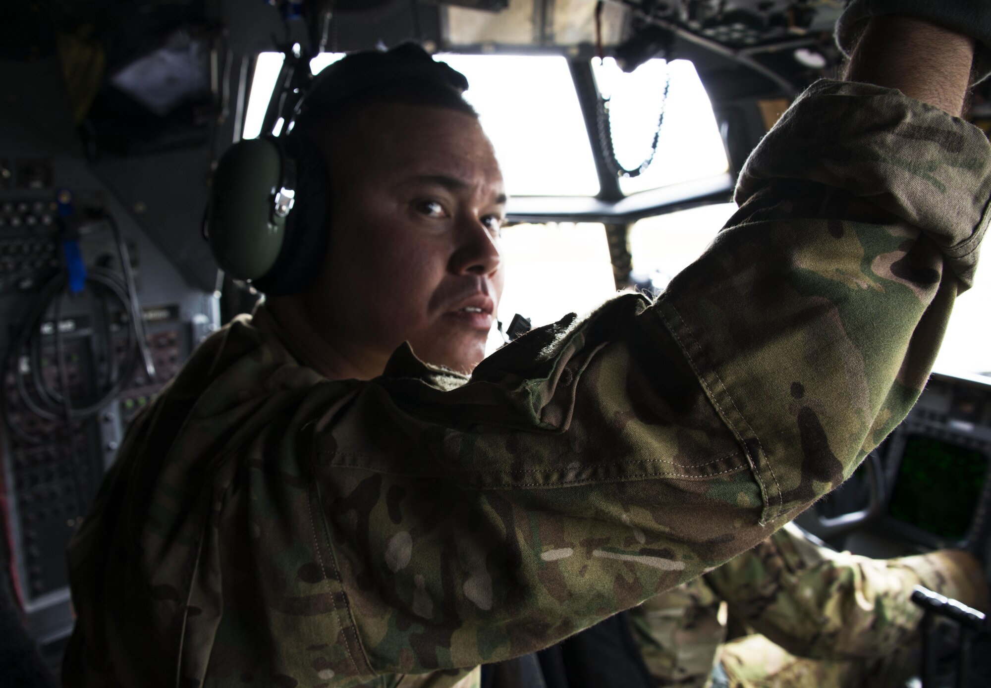 Master Sergeant Kenneth Thompson, 1st Special Operations Squadron flight engineer looks out the window of a MC-130H Combat Talon II as the crew prepares for take off at Kadena Air Base, Sept. 22. The crew transported equipment and personnel to Clark Air Base and Mactan-Benito Ebuen Air Base for Teak Piston 2016, a joint-combined exchange training (JCET) conducted with several units from the Philippine Air Force. (U.S. Air Force photo by Capt. Jessica Tait)
