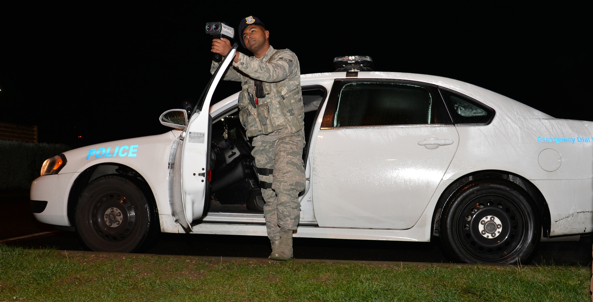 U.S. Air Force Airman 1st Class Robin John, 100th Security Forces Squadron response force member, checks traffic speed Oct. 12, 2016, on RAF Mildenhall, England. John works the night shift defending the gates and ensuring the base community is safe. (U.S. Air Force photo by Gina Randall)