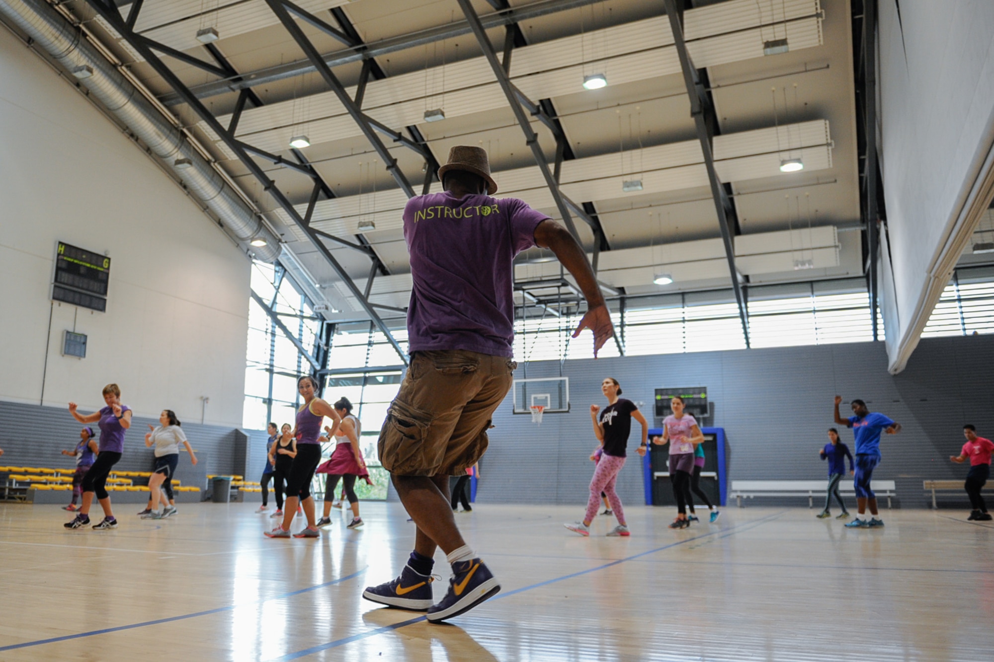 Master Sgt. Willie Williams, 86th Medical Support Squadron laboratory NCO in charge, instructs a Zumba class held to raise awareness for domestic violence at Ramstein Air Base, Germany, Oct. 14, 2016. Williams and two other instructors led a group of approximately 35 people through a series of Zumba dance exercises. (U.S. Air Force photo by Airman 1st Class Savannah L. Waters)