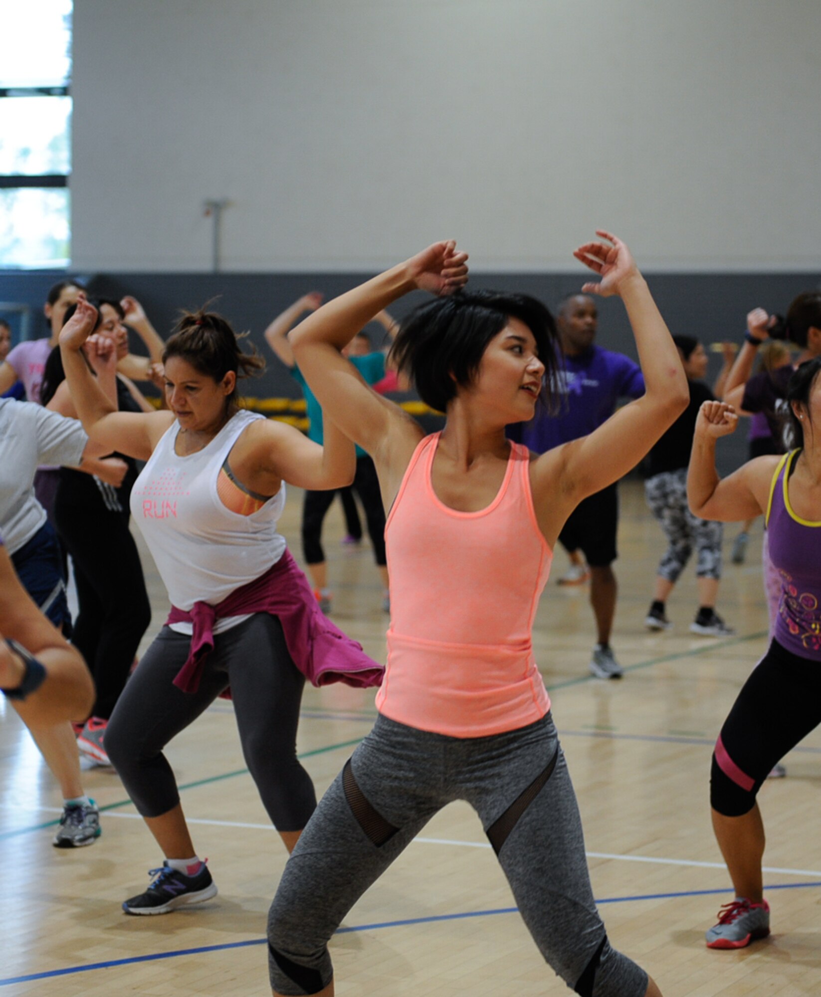 Mayuka Bolivar dances in a Zumba class held to raise awareness for domestic violence at Ramstein Air Base, Germany, Oct. 14, 2016. Zumba Fitness is a Latin inspired cardio-dance workout that uses music and choreographed steps, where participants imitate the steps of the instructor. The Family Advocacy Program hosted the event to help people gain information and awareness about domestic violence. (U.S. Air Force photo by Airman 1st Class Savannah L. Waters)