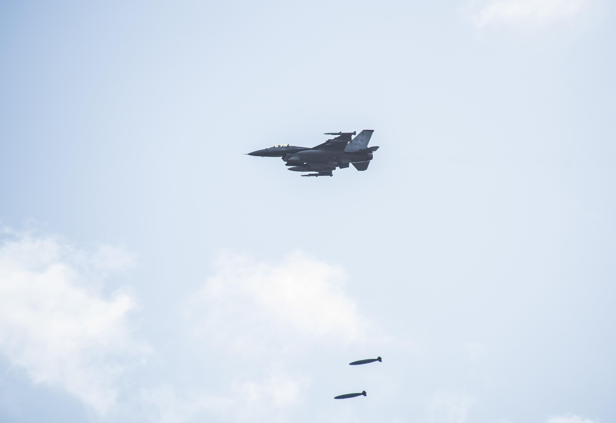 An F-16 Fighting Falcon deploys two, two-thousand pound inert bombs during a Range Day event at Misawa Air Base, Japan, Oct. 21, 2016. During the F-16 demonstration, they performed low-angle strafe gunning runs and various general ballistic bombing techniques. (U.S. Air Force photo by Airman 1st Class Sadie Colbert