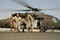 First responders from the 386th Expeditionary Civil Engineer Squadron fire department and the 386th Expeditionary Medical Group carry a simulated casualty during medical evacuation training Oct. 14, 2016 at an undisclosed location in Southwest Asia. Army flight medics led Air Force first responders and coalition partner medical personnel in medical evacuation training to improve mission capabilities. (U.S. Air Force photo/Senior Airman Zachary Kee)