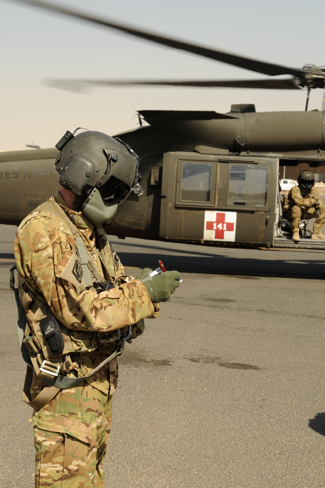 U.S. Army Sgt. John Tsohandaridis, flight medic, makes a note while watching a patient load during medical evacuation training Oct. 14, 2016 at undisclosed location in Southwest Asia. Army flight medics led the training that supported Air Force and coalition partner medical teams to enhance mission capabilities. (U.S. Air Force photo/Senior Airman Zachary Kee)