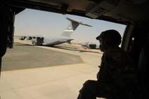 U.S. Army Spec. Shane Finnegan, HH-60G Pave Hawk helicopter crew chief, looks out the side of the aircraft while taking off from the flight line Oct. 14, 2016 at an undisclosed location in Southwest Asia. Finnegan is the crew chief responsible for the HH-60G that was used during the medical evacuation training conducted by Army flight medics. (U.S. Air Force photo/Senior Airman Zachary Kee)