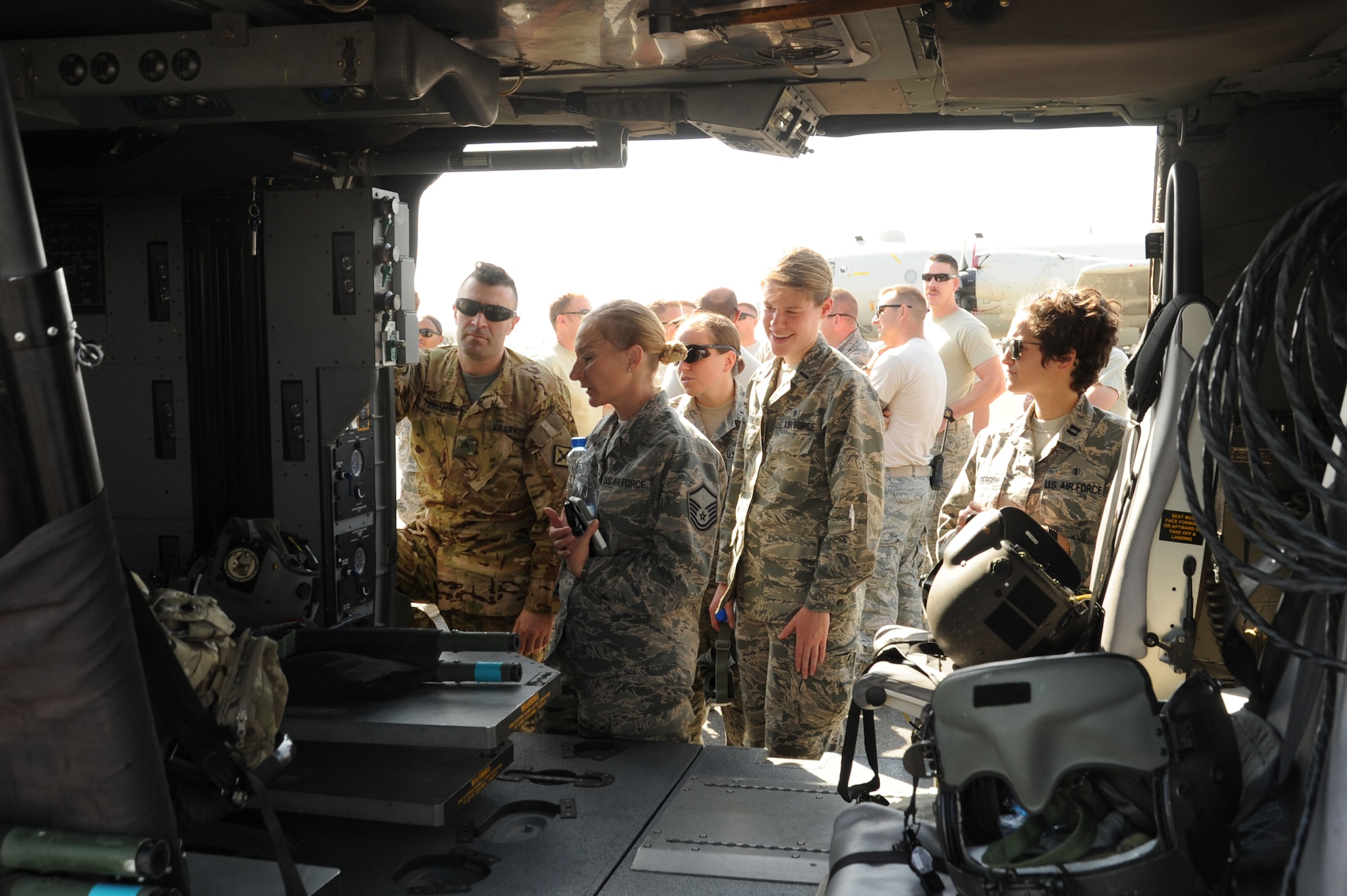 Airmen from the 386th Expeditionary Medical Group look inside an HH-60G Pave Hawk helicopter prior to medical evacuation training Oct. 14, 2016 at an undisclosed location in Southwest Asia. The training gave the 386 EMDG Airmen the opportunity to “hot load” a simulated patient with the rotors running on the aircraft. (U.S. Air Force photo/Senior Airman Zachary Kee)