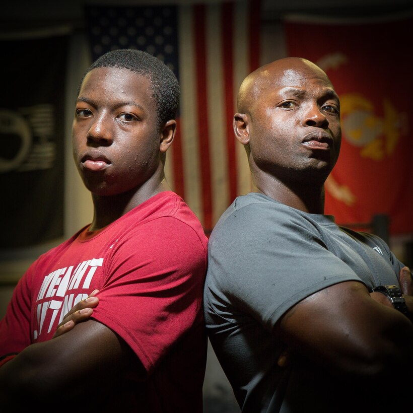 Braylin X. Young, left, stands with his inspiration and father, Master Sgt. Trevor C. Young. Braylin, who won the 14-15 Individual 85 kg at the USA Weightlifting National Youth Competition held in June in Austin, Texas, got started lifting weights by his father who first brought him along to workouts as a way to do some father-son bonding. (Photo by Staff Sgt. Greg Thomas)