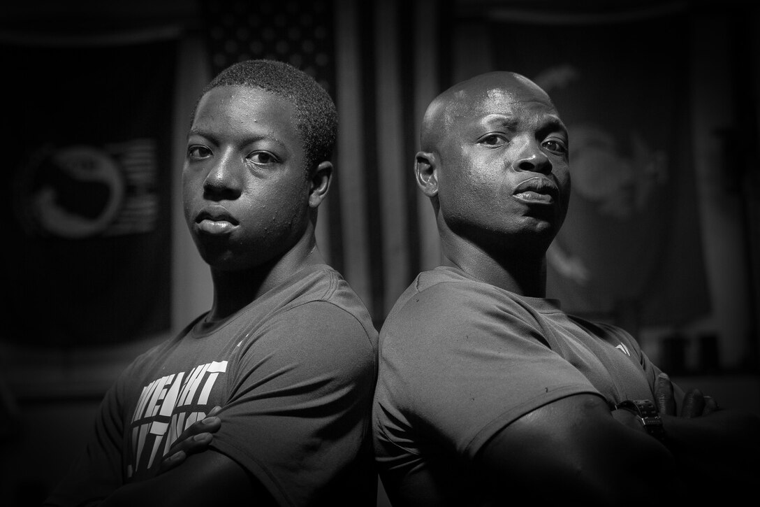 Braylin X. Young, left, stands with his inspiration and father, Master Sgt. Trevor C. Young. Braylin, who won the 14-15 Individual 85 kg at the USA Weightlifting National Youth Competition held in June in Austin, Texas, got started lifting weights by his father who first brought him along to workouts as a way to do some father-son bonding. (Photo by Staff Sgt. Greg Thomas)
