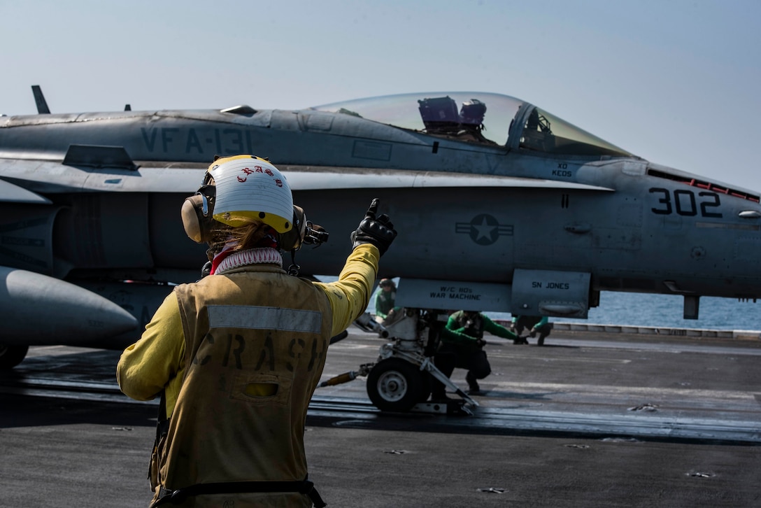 161020-N-QI061-024

ARABIAN GULF (Oct. 20, 2016) Petty Officer 3rd Class Gabrielle Embry signals to an F/A-18F Super Hornet assigned to the Wildcats of Strike Fighter Squadron (VFA) 131 on the flight deck of the aircraft carrier USS Dwight D. Eisenhower (CVN 69) (Ike). Embry serves as an aviation boatswain’s mate (handling) aboard Ike. Ike and its Carrier Strike Group are deployed in support of Operation Inherent Resolve, maritime security operations and theater security cooperation efforts in the U.S. 5th Fleet area of operations. (U.S. Navy photo by Petty Officer 3rd Class Nathan T. Beard)