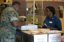 Petty Officer Shaunta Brown signs in to the chow hall for the 241st Navy Birthday Meal held at Marine Corps Air Station New River, October 13, 2016. The meal included Grilled Steak, Baked Lobster Tails, Shrimp Cocktail and other side dishes. DOD employees, dependents of Marines, Military Retirees, Guests of Marines and Sailors and guests of the Commanding General were all eligible to attend. Brown is a hospital corpsman with Marine Aircraft Group-26. (U.S. Marine Corps photo by Cpl. Melodie Snarr/Released.)