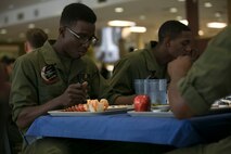 Cpl. Roldy Jaques and Sgt. Raveem Foster enjoy the 241st Navy Birthday Meal held at Marine Corps Air Station New River, October 13, 2016. The meal included Grilled Steak, Baked Lobster Tails, Shrimp Cocktail and other side dishes. DOD employees, dependents of Marines, Military Retirees, guests of Marines and Sailors and guests of the Commanding General were all eligible to attend. Jaques and Foster are avionics technicians with Marine Medium Tilt-rotor Training Squadron 204. (U.S. Marine Corps photo by Cpl. Melodie Snarr/Released.)