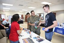 Marines with Headquarters and Headquarters Squadron learn about local resources during an information fair and chili cook off, on Marine Corps Air Station New River Oct. 7. The event brought service members and their families together to learn about local resources and enjoy a day at the marina . (U.S. Marine Corps photo by Cpl. Mark Watola/Released)
