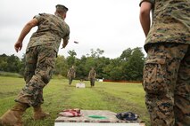 Marines with Headquarters and Headquarters Squadron play corn hole during an information fair and chili cook off, on Marine Corps Air Station New River Oct. 7. The event brought service members and their families together to learn about local resources and enjoy a day at the marina . (U.S. Marine Corps photo by Cpl. Mark Watola/Released) 
