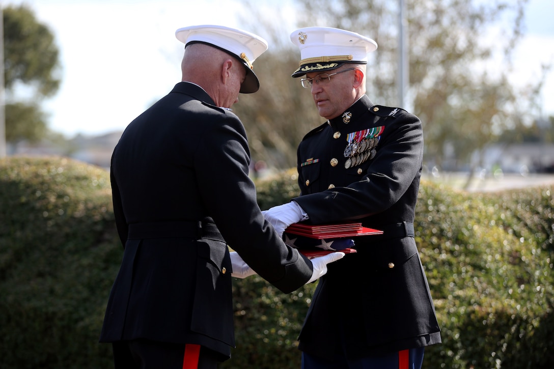 Retired Maj. Gen. Charles L. Hudson presents Col. Yori R. Escalante a folded American flag and other awards at Marine Corps Base Camp Lejeune, Oct. 14. Col. Yori R. Escalante, deputy commander of Marine Corps Installation East - Marine Corps Base Camp Lejeune, retired today after 30 years of faithful and dedicated service to the Marine Corps. (U.S. Marine Corps photo by Pfc. Juan Madrigal/Released)